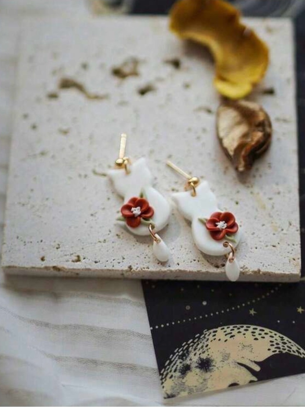 Handcrafted White Cat Drop Earrings with Coral Flower Accent